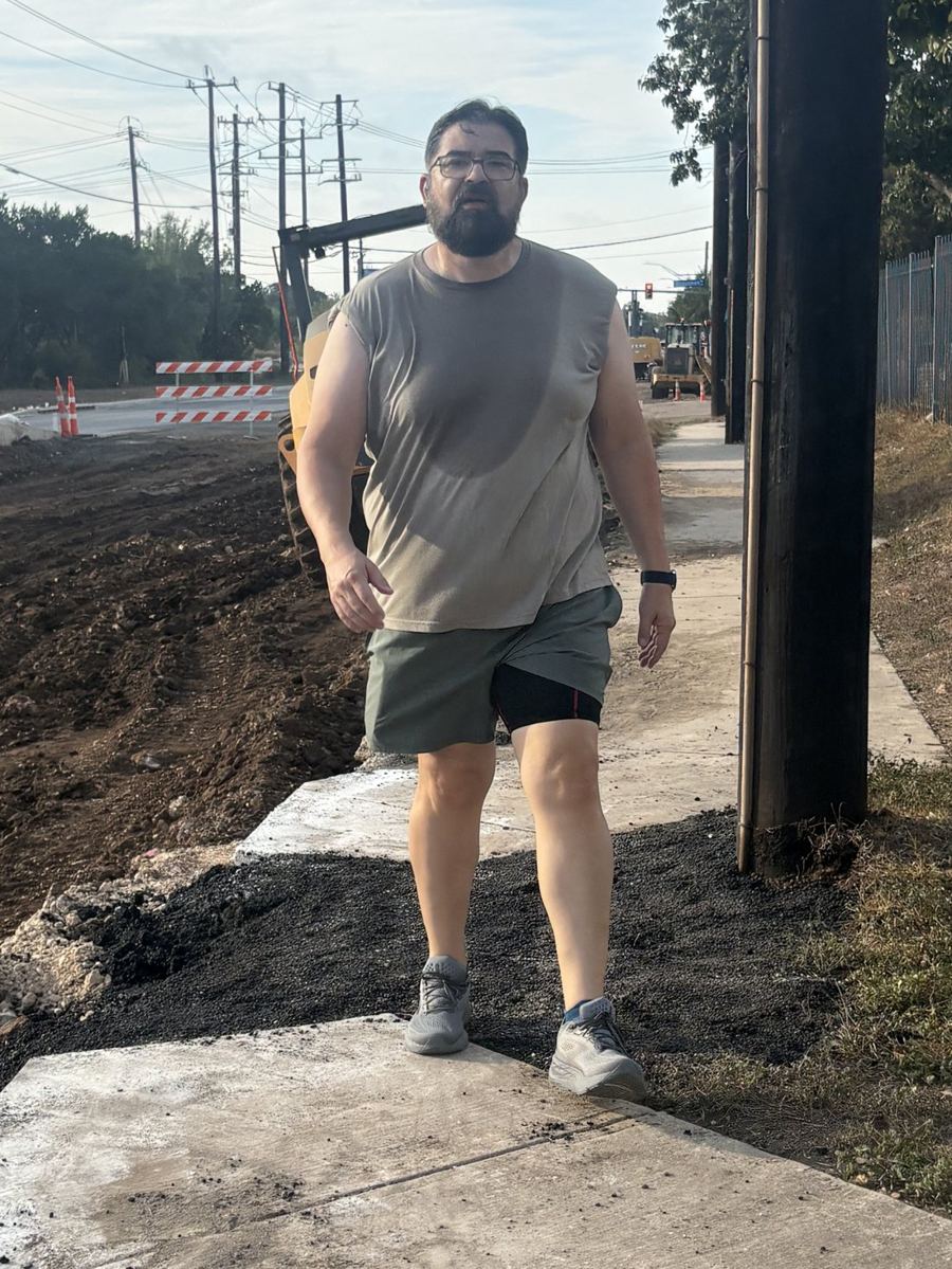Andres Delgado finishing a run on a San Antonio sidewalk next to road construction